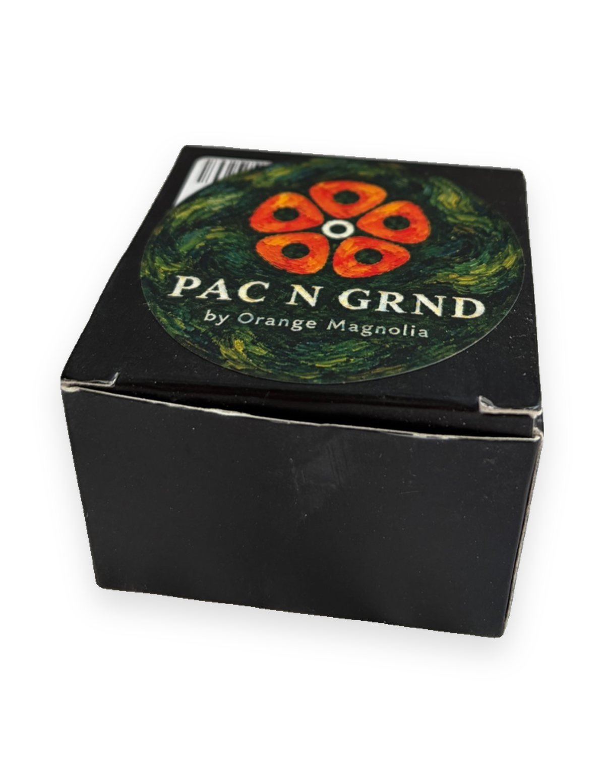 Pac n Grnd box with the Orange Magnolia badge on the lid