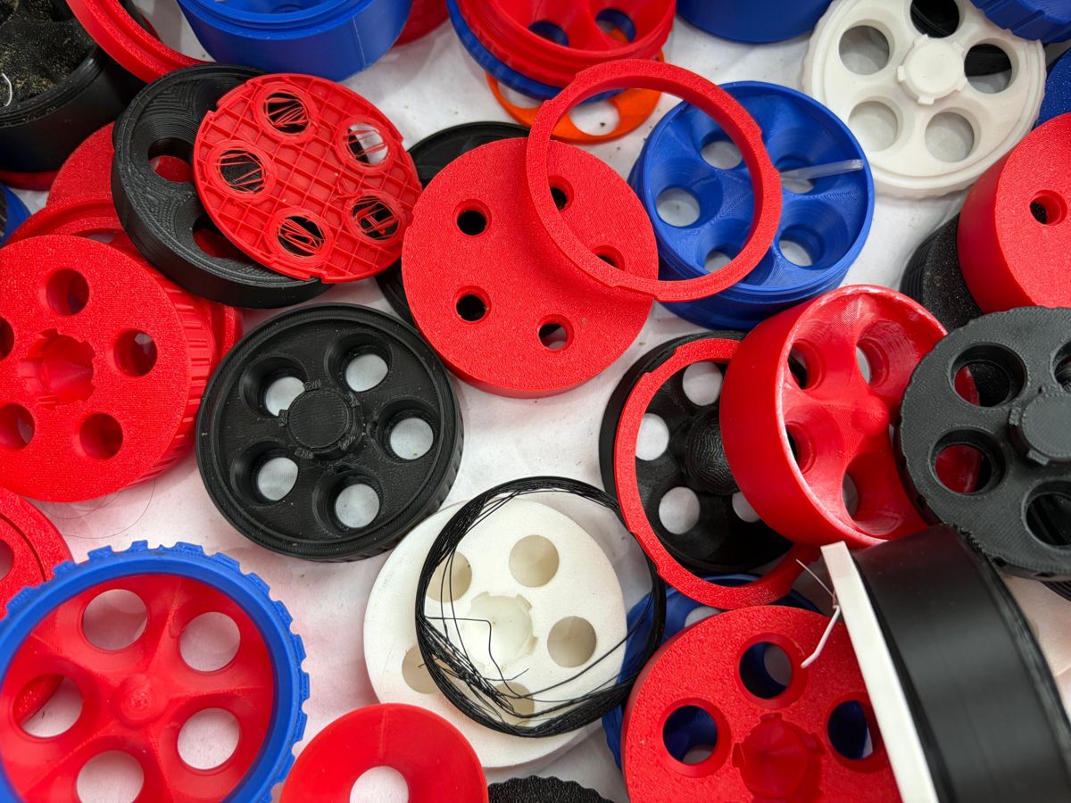 A pile of earlier prototype docks and holders in red, blue, black and white